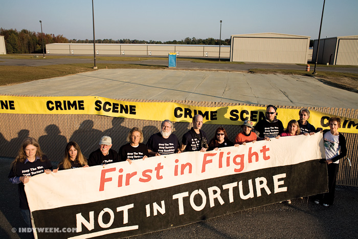 NC Stop Torture Now is an award-winning anti-torture protest group; this photo was taken in front of Aero Contractors' hangars, which are now hidden behind several new fences.